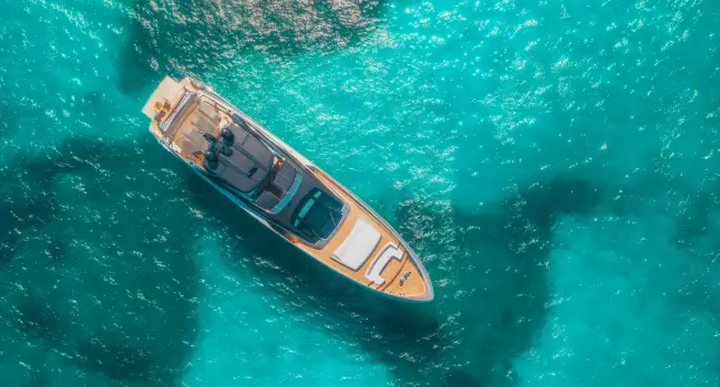 Luxury yacht cruising on the calm Mediterranean waters under a sunny sky.