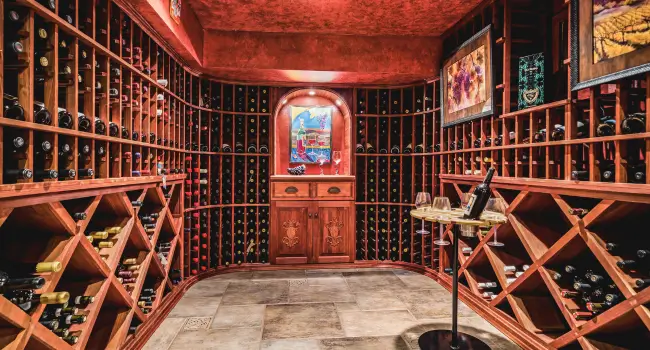 Elegant Tuscan wine cellar with wooden barrels and wine racks.